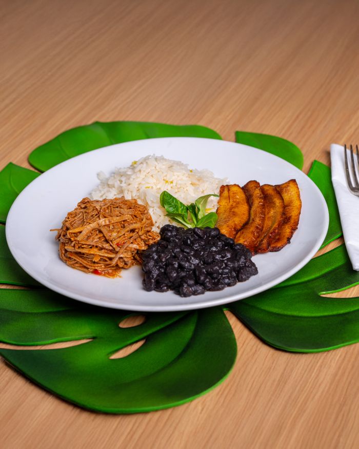 services-02 Authentic Latin American dish with pulled beef, black beans, rice, and plantains.