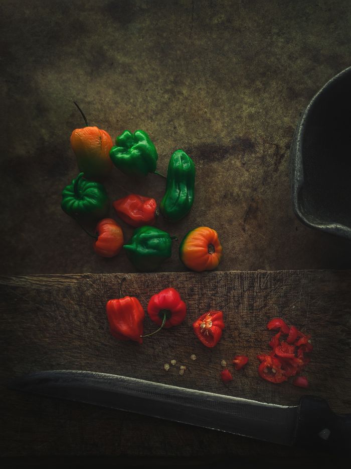 about-us-02 Colorful assortment of peppers on a rustic wooden surface, perfect for food photography and cooking inspiration.